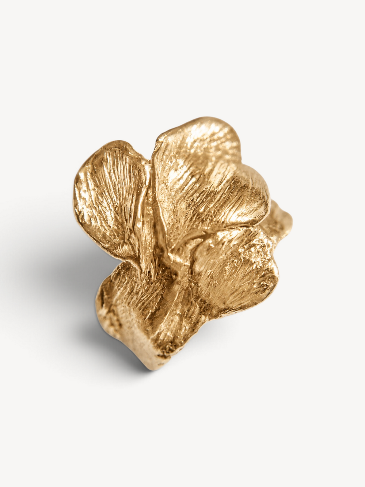 Angled front view of a handcrafted 14k gold-plated sterling silver sculptural ring with an organic leaf-inspired design.