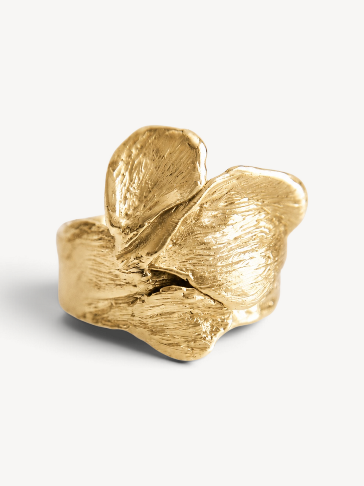 Front view of a contemporary 14k gold-plated sterling silver statement ring featuring layered organic leaf textures.