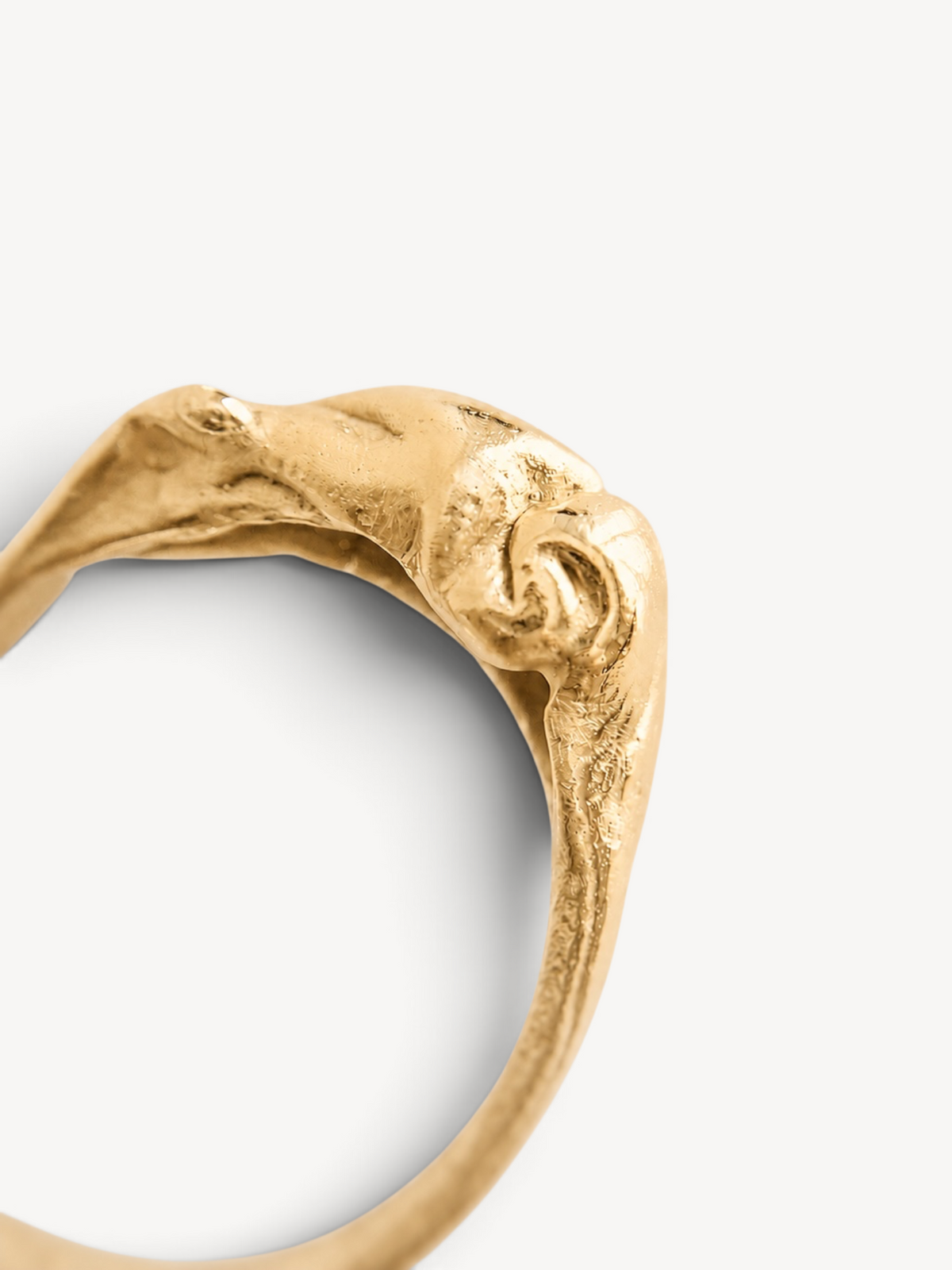 Macro detail of a handcrafted 14k gold-plated sterling silver ring with an organic sculptural texture.