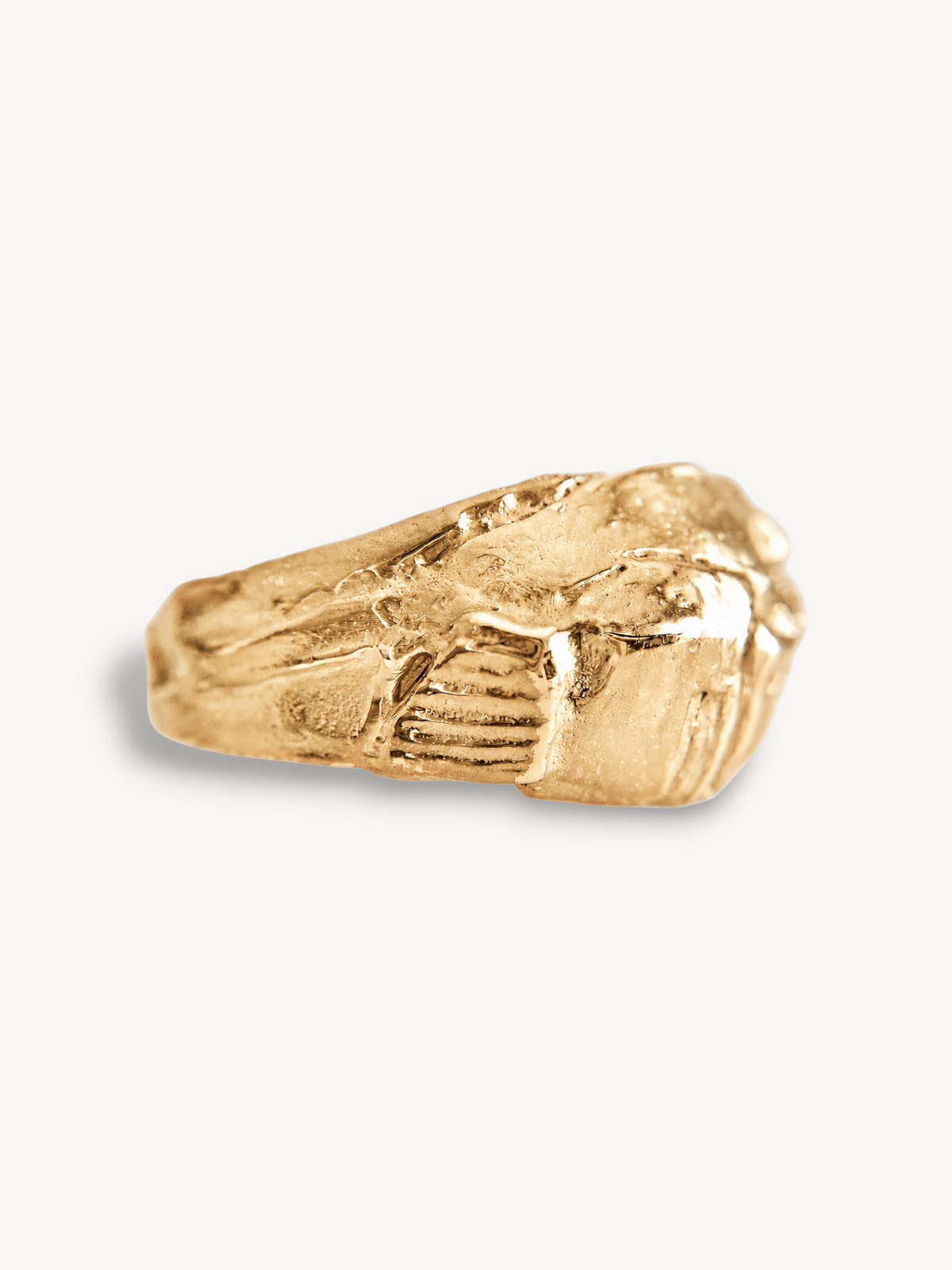 Side profile of a handcrafted 14k gold-plated sterling silver statement ring featuring an organic textured band.