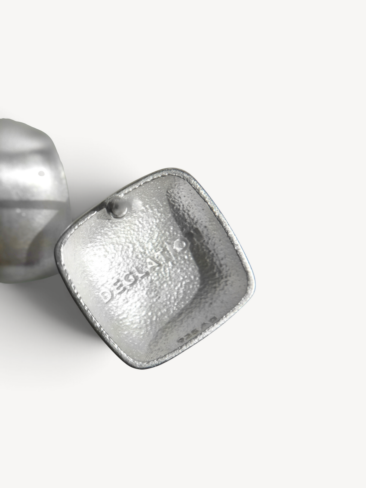 Back view of handcrafted rhodium-plated sterling silver square stud earrings showcasing secure post backs and quality artisan finishing.