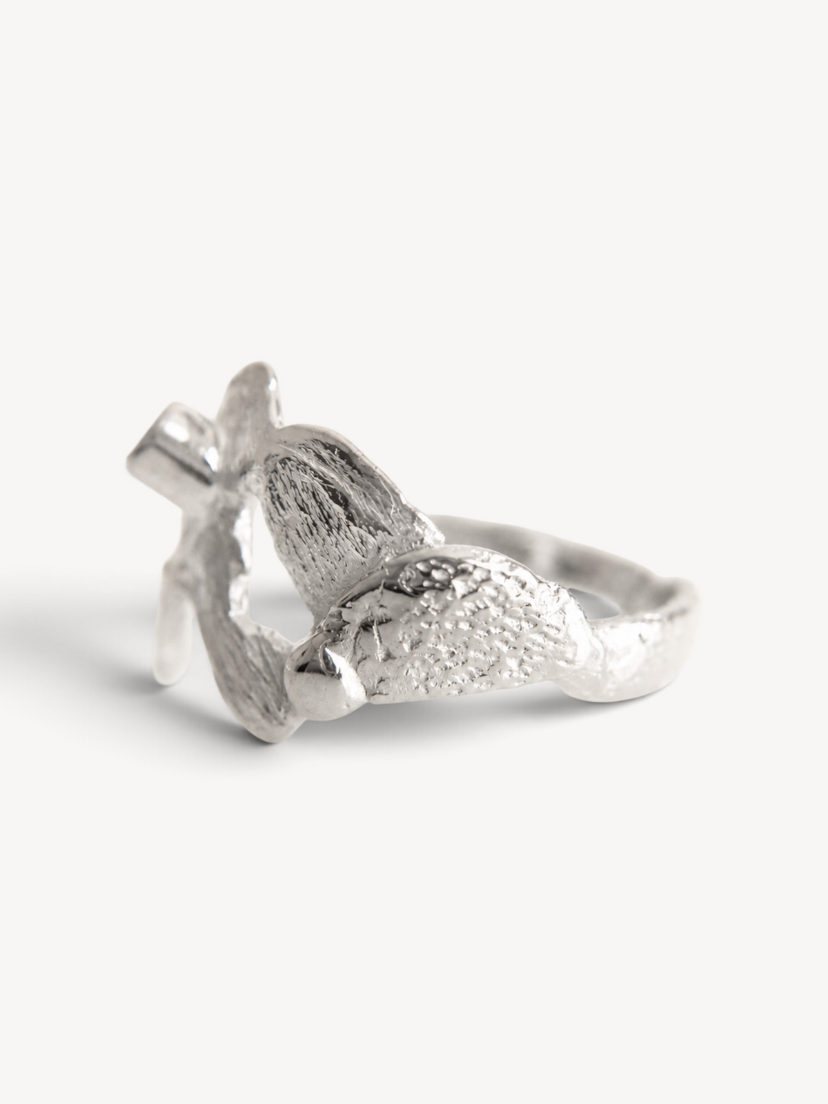 Underside view of a handcrafted rhodium-plated sterling silver ring highlighting its open sculptural construction and artisan craftsmanship.